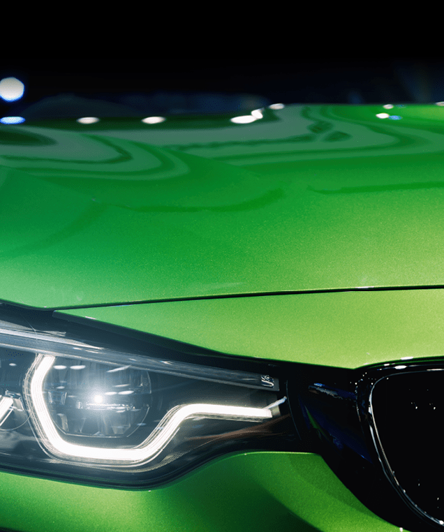 Closeup headlights of modern car during turn on light in night.