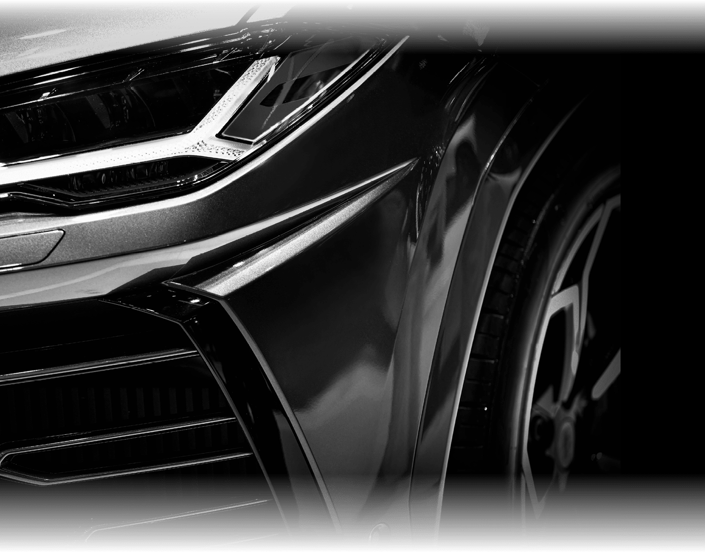 Detail on one of the LED headlights super car on black background, free space on right side for text.