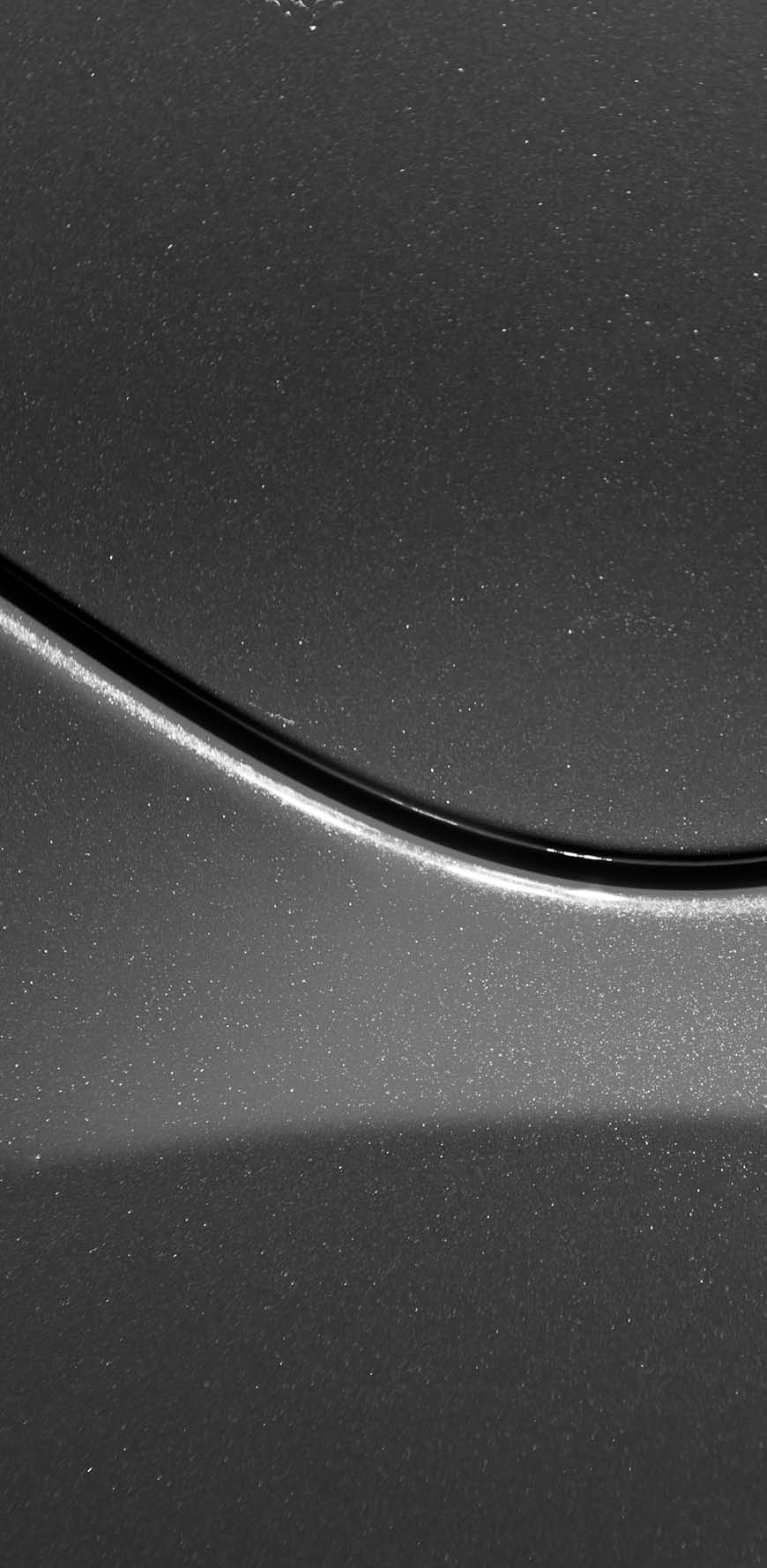 Smooth curves of bright yellow metal car body. Abstract - steel post envelope.