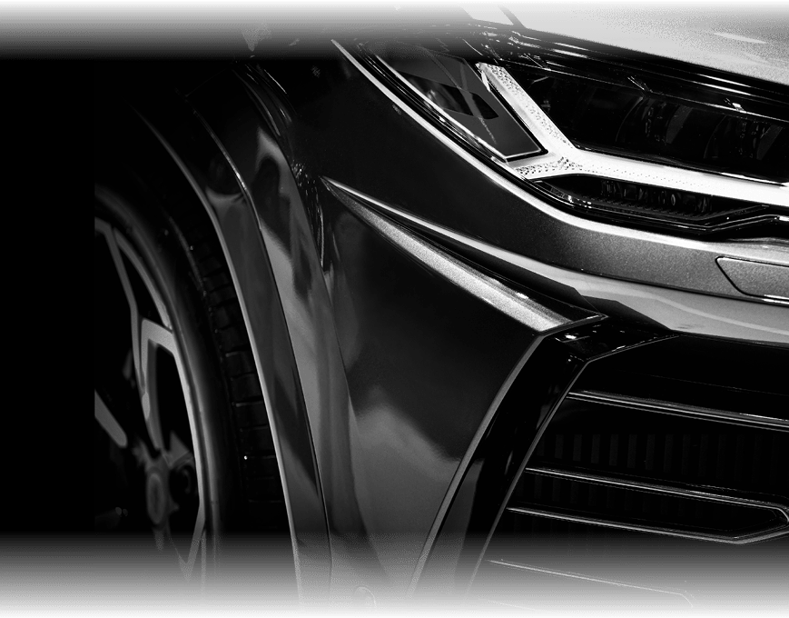 Detail on one of the LED headlights super car on black background, free space on right side for text.