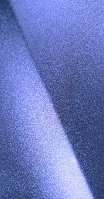 Fragment of blue steel car bodywork, vehicle silver paint coating texture, selective focus, abstract 