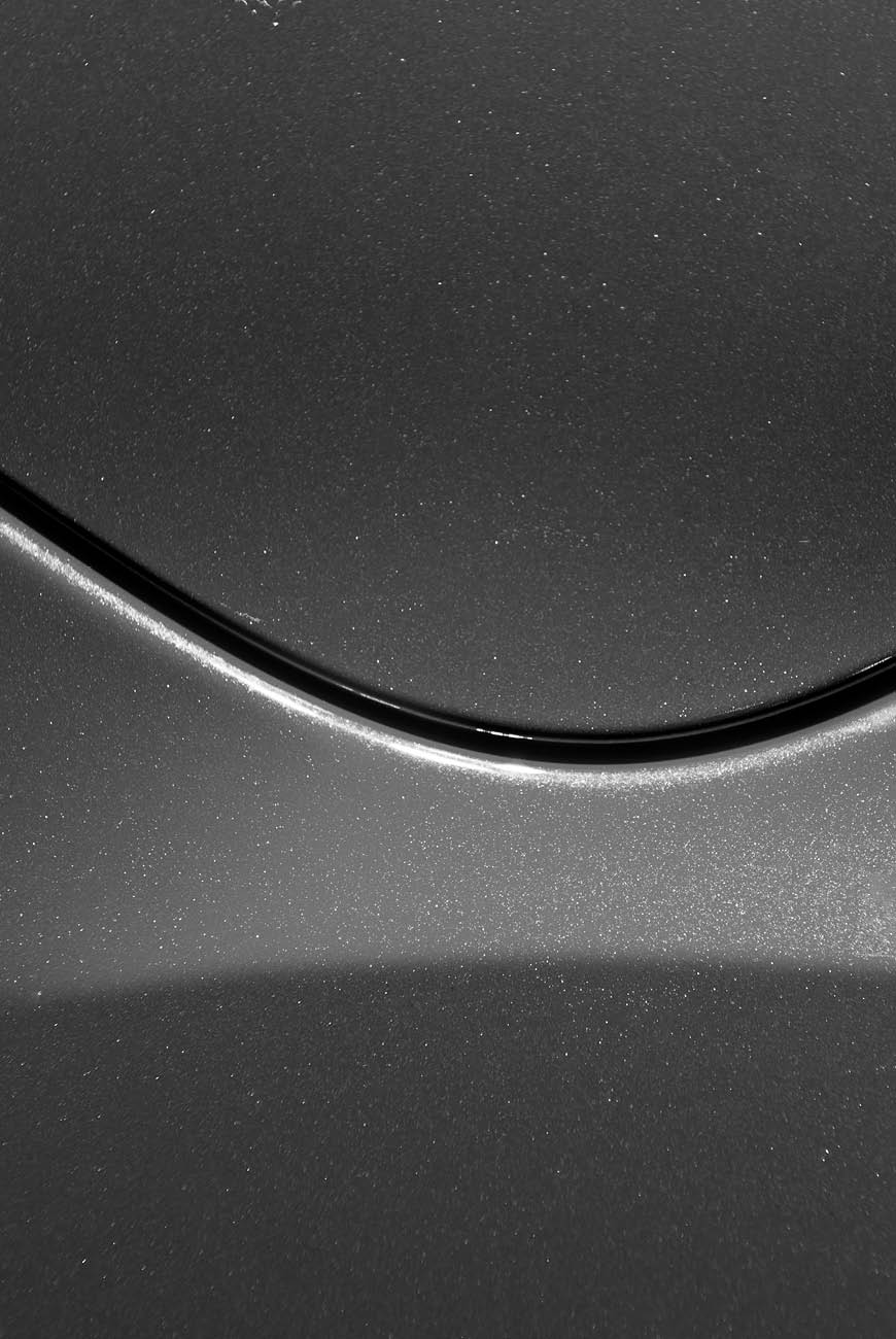 Smooth curves of bright yellow metal car body. Abstract - steel post envelope.